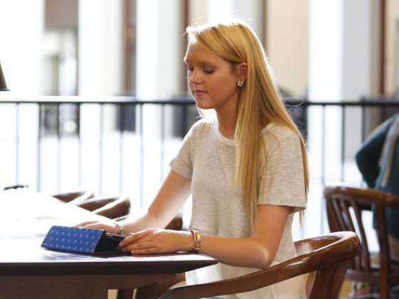 Student sitting at desk with laptop